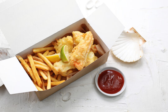 Deep fried shrimps, prawns in tempura, in a take-away carton box, on a white background.