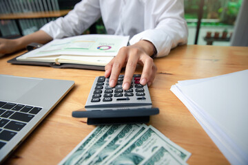 Business woman accountant or banker using calculator in office. Savings, finances and economy concept.