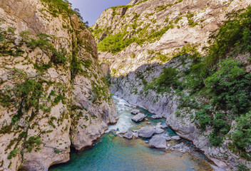 The purest waters of the turquoise color of the river Moraca flowing among the canyons. Travel around Montenegro concept Portrait of a disgruntled girl sitting at a cafe table