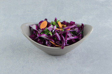 A bowl of grated vegetables, on the marble background