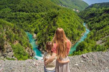 Mom and son tourists on the background River bend, Montenegro,.natural landscape, mountain river...