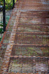 A metal grid background was used to create a high-altitude walking grate as it was lighter than concrete and was visible below. Full frame metal grid backgrounds are perfect for design projects.