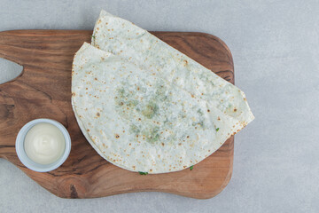 Azerbaijan national cuisine. Gutab, on a cutting board , on the marble background