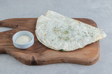 Azerbaijan national cuisine. Gutab, on a cutting board , on the marble background