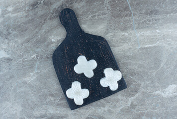 Cross shaped radish on board, on the marble background