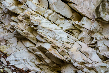 Texture cracked rock formation rock in the wild. Background with copy space