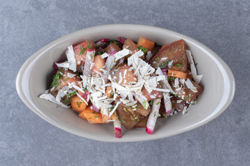  A bowl of mixed grated vegetables, on the marble background