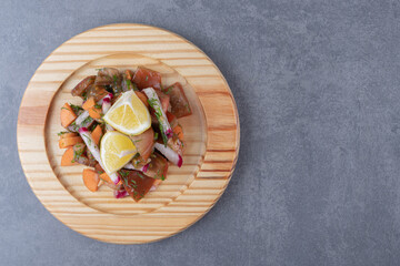 A kind of vegetables in the wooden plate , on the marble background