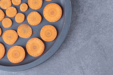 Sliced carrots in a pan, on the marble background