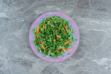 Fototapeta na wymiar Grated greens on the plate , on the marble background