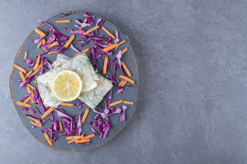 Sliced lemon, red cabbage and carrot with folded gutab , on the marble background