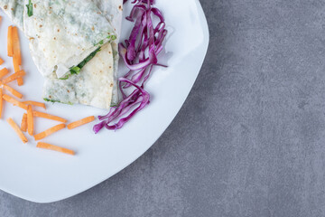 Sliced red cabbage and carrot with folded gutab , on the marble background