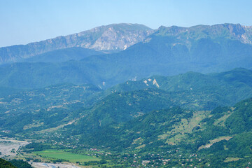 Georgian mountain landscape with a country road, a view of the woodlands