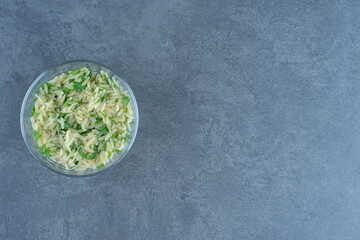 Delicious rice with greens in glass bowl