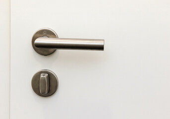 Modern Handle Door Lock. White Door with Gray Stainless Steel Door Knob in Apartment.