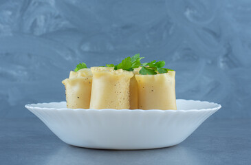 Boiled dough rolls in white bowl