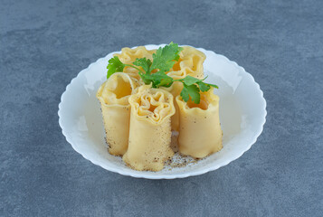 Boiled dough rolls in white bowl