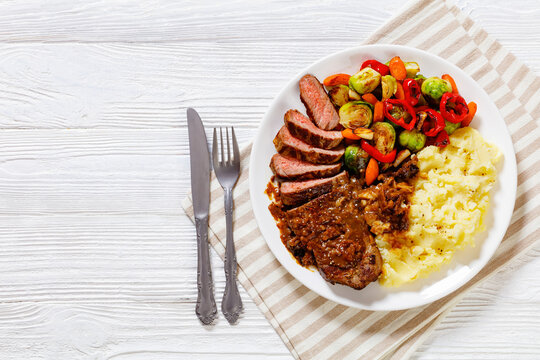 beef steak with potato mash and roasted vegetables