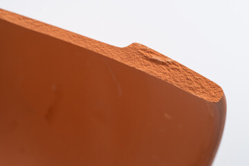 Broken terracotta pot close up on isolated white background. Manufactured defect. Shipment risk.