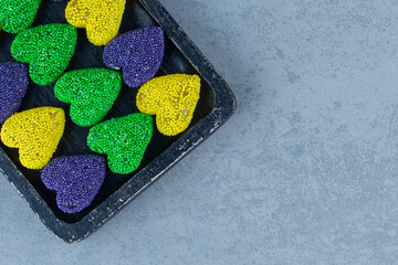 Colorful cookies on the board , on the marble background
