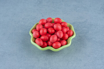 Red gums in the bowl, on the marble background