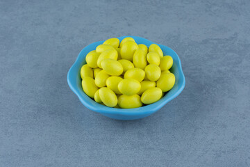 Yellow gums in the bowl, on the marble background