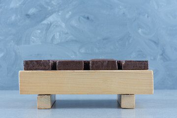 Chocolate coated on crispy wafer bar on the board, on the marble background