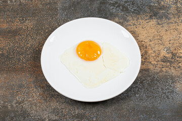 Delicious fried eggs on white plate
