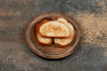 Three toasted bread on wooden board