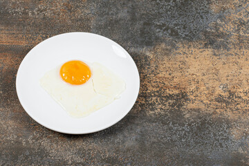 Delicious fried eggs on white plate