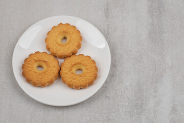 Tasty sweet biscuits on white plate