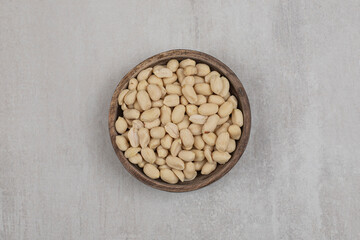 Bunch of peeled peanuts in wooden bowl