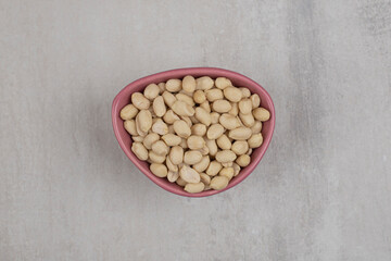 Organic tasty peanuts in pink bowl