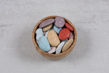 Colorful various stone candies in wooden bowl