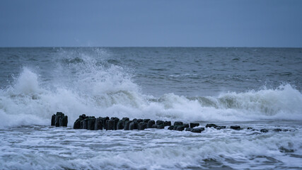 storm waves crash on the breakwater
