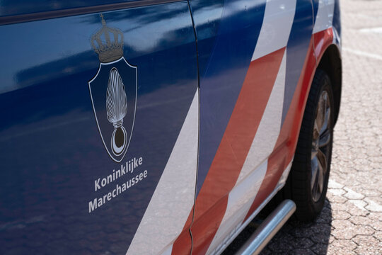 HOEK VAN HOLLAND, NETHERLANDS, SEPTEMBER 6 2022: Logo and words of the Dutch 'Royal Marechaussee' on the door of a van. It is the national gendarmerie force of the Kingdom of the Netherlands