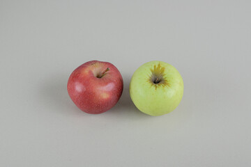 Red and green fresh apples on gray background