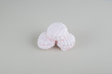 Three sweet marshmallow cakes on gray background