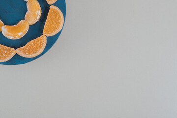 A wooden board with orange sugar marmalade