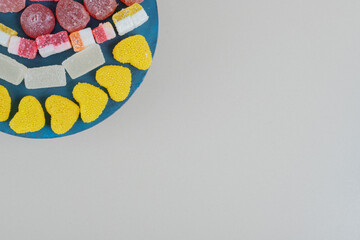 A wooden board full of sugary jelly candies