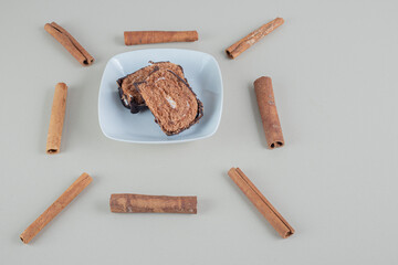 Sliced sweet chocolate roll with cinnamon sticks