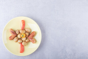Tasty fried potatoes on yellow plate