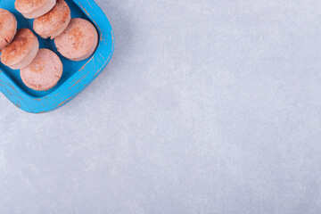 Sliced fried sausages on blue plate