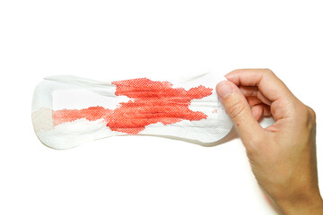 compress with blood from the period held by a hand on a white background