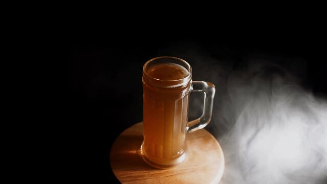 Glass of beer on dark background 4k