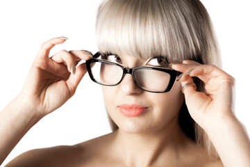 Portrait of a beautiful brunette girl with blond bangs fringe. Wearing glasses. .