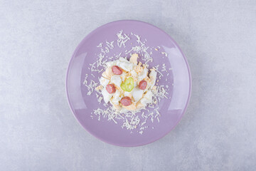 Fototapeta na wymiar Grated cheese and egg with sausages on purple plate