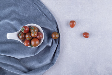 Bunch of cherry tomatoes in white bowl