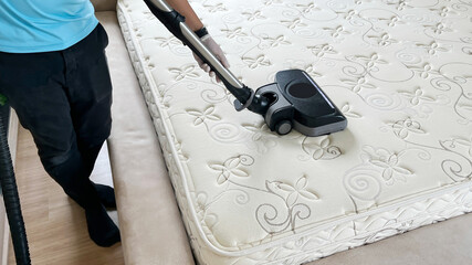 Professional cleaning and sanitizing services use industrial vacuum cleaner to clean and get rid of...