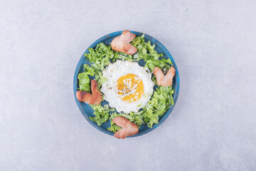 Fried sausages and egg on blue plate